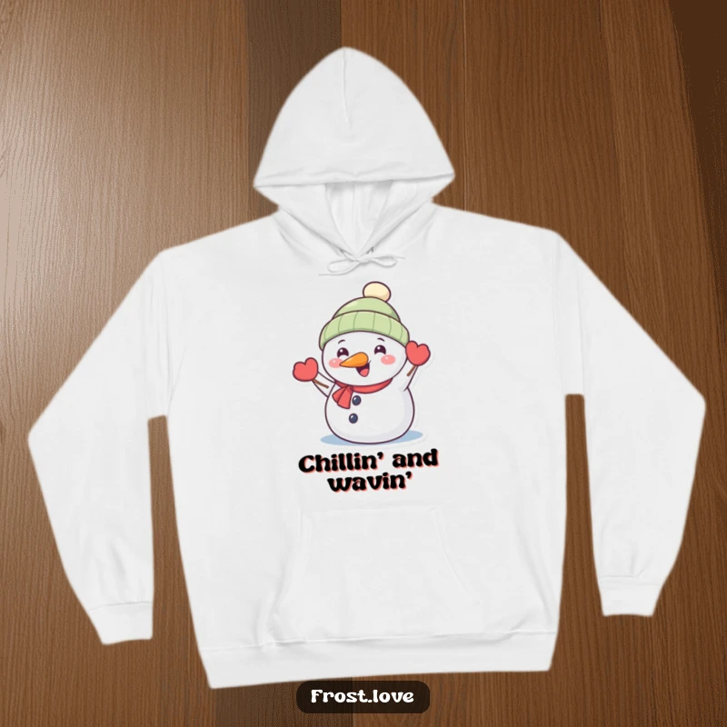 Funny Kawaii snowman with carrot nose happily waving hoodie, cute winter character clothing, humorous holiday comfort.